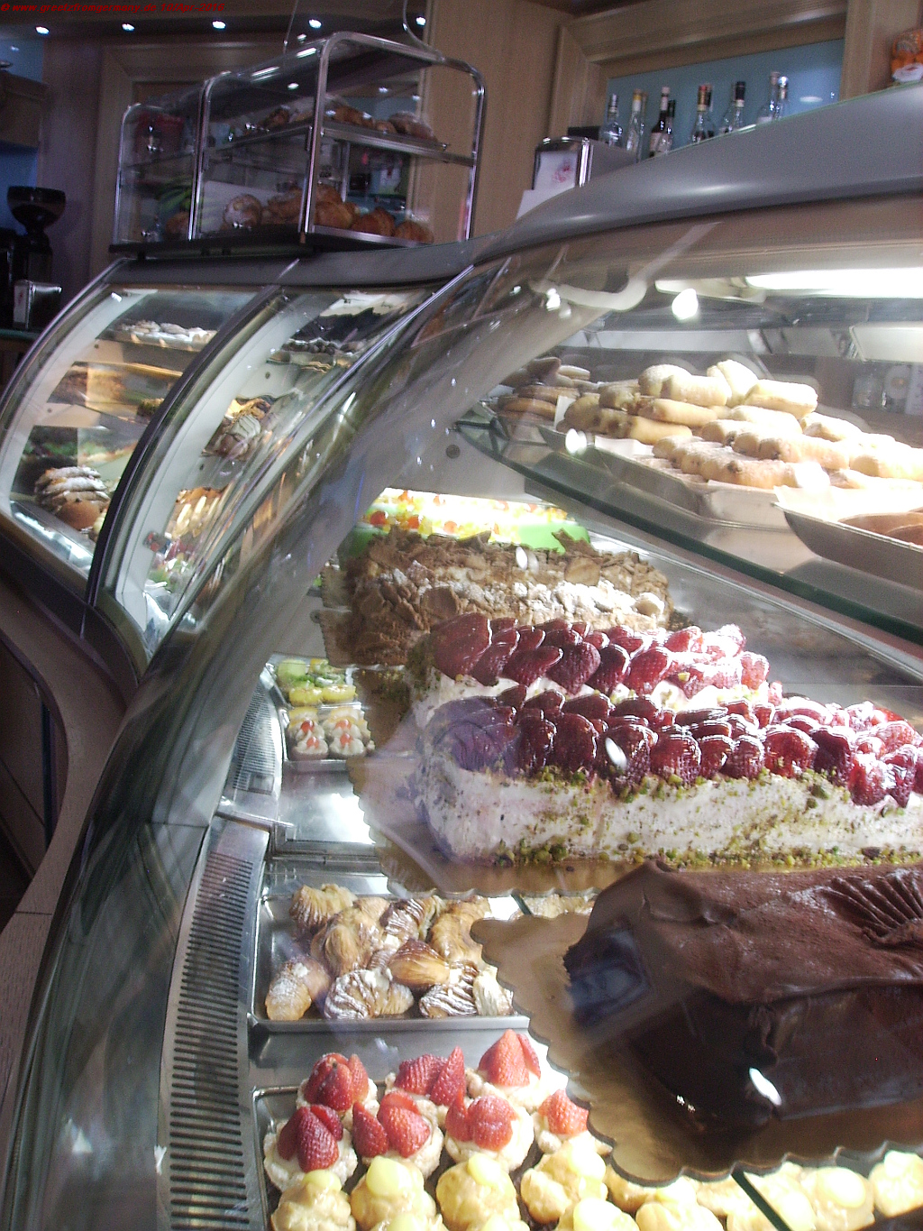 A typical small village bakery display of assorted cakes and sweets.